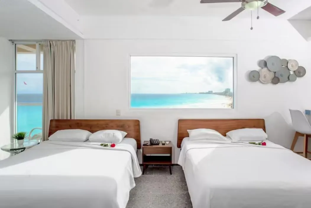 Recámara principal con dos camas queen del departamento 604AB en Salvia, Zona Hotelera de Cancún